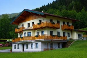 a building with wooden balconies on the side of it at Appartement Tauernhof in Kleinarl