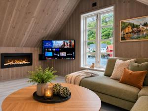 a living room with a couch and a tv at Stunning 3-Bedroom Apartment at Feda Waterfront in Feda