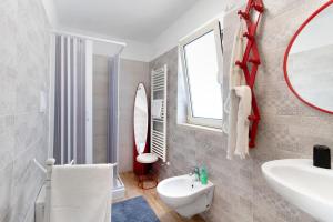 a bathroom with a sink and a mirror at La Mansarda - Terrazze Relax A Due in Cellamare +27 photos
