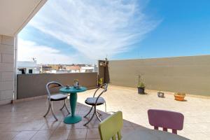 a patio with a table and chairs on a roof at La Mansarda - Terrazze Relax A Due in Cellamare