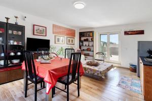 a dining room with a red table and chairs at La Mansarda - Terrazze Relax A Due in Cellamare
