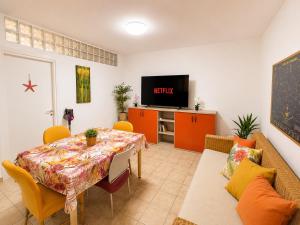 a living room with a table and a tv at Belvedere Apartment in Casa Donato