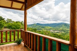 a porch of a cabin with a view of mountains at Cabañas Bella Vista in Hojancha