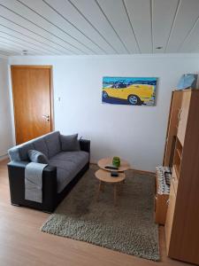 a living room with a couch and a table at Dirks Apartment mit Weitblick in Mammelzen