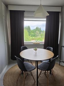 a table and chairs in a room with a window at Apartments at Koulukatu in Savonlinna