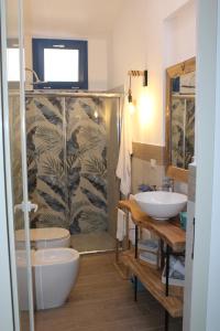 a bathroom with two sinks and a toilet and a shower at Casa Briseida in Baia Verde +37 photos