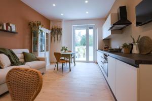 a kitchen and living room with a couch and a table at Dimore Tinè in Castellana Grotte