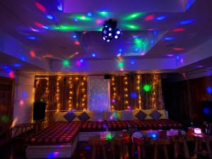a room with a couch and a stage with lights at Ping Dara Pool Villa Party in Ban San Pa Sak +6 photos