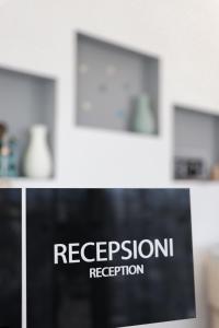 a close up of a sign that says regressionxual reception at Hotel Alga Velipoje in Velipojë