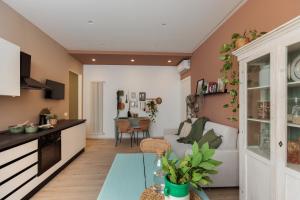 a kitchen and living room with a couch and a table at Dimore Tinè in Castellana Grotte