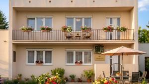 a building with flowerpots on a balcony at Villasobota in Rimavská Sobota