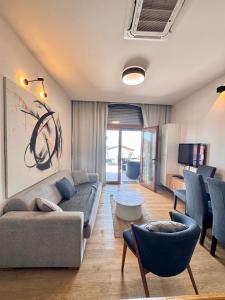 a living room with a couch and a table at Apartments Lungo Mare in Sveti Stefan