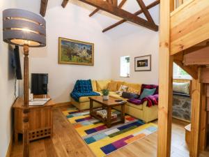 a living room with a couch and a table at Ty Loti in Caernarfon
