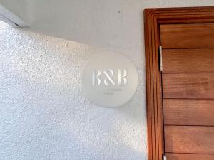 a circular sign on a wall next to a door at BRICKS and BLOCKS MIYOTA in Miyota