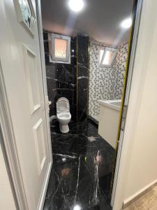 a small bathroom with a toilet and a sink at Nesma Douaouda in Douaouda