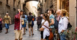 a group of people walking down a street at Sun & Moon Hostel in Barcelona