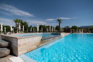 a large swimming pool with blue water at Vrnjačko Vrelo Resort in Novo Selo
