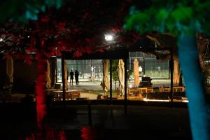 a group of umbrellas and tables and chairs at night at Vrnjačko Vrelo Resort in Novo Selo +73 photos