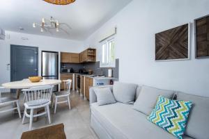 a living room and kitchen with a couch and a table at Naxos Infinity Villa and Suites in Naxos Chora