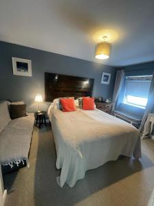 a bedroom with a large bed and a couch at Skyline Guesthouse Newquay in Newquay