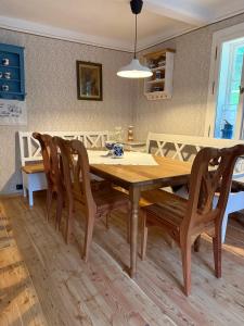 a dining room with a wooden table and chairs at Dom Na Biegunach in Cięcina +7 photos
