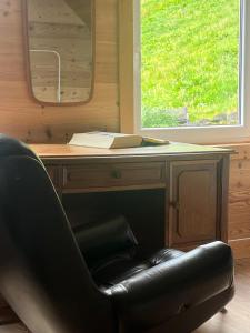 a black leather chair sitting in front of a desk at Fjord House Hardanger in Grimo +34 photos