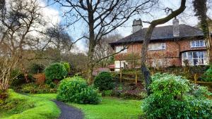 a brick house with a walkway in front of a yard at Secluded Seven Room House in Okehampton