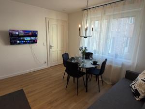 a dining room table and chairs in a living room at Home&Living - Casa Nova in Meerbusch