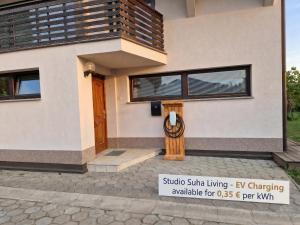 a house with a sign in front of it at Studio Suha living in Škofja Loka