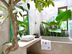a bathroom with a sink and a tree in it at GODDESS Kandy in Kandy +46 photos