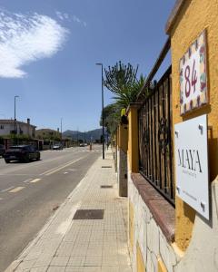 a sign on the side of a building next to a street at Maya Apartments in La Maddalena +8 photos