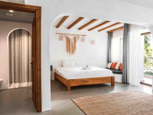a white bedroom with a bed and a table at Kassandra Oludeniz in Oludeniz