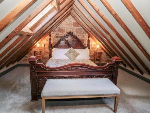 a bedroom with a bed in a attic at Stable Lodge in Berwick-Upon-Tweed