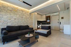 a living room with a couch and a table at Afitos Luxury Villas in Afitos +32 photos