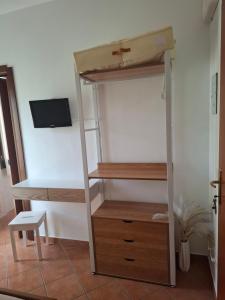 a room with a bunk bed and a desk at Cascina Volpi in Montegrino Valtravaglia