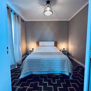 a bedroom with a large bed with two night stands at Cottagee Grandpa Silva in Santana +17 photos