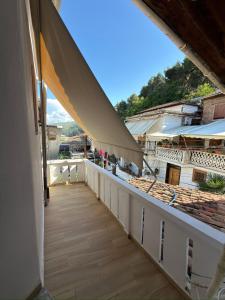 a balcony with a view of a building at Xhulio Guesthouse Berat in Berat