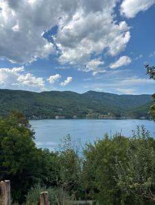 a view of a lake with mountains in the background at Perucac Apartman in Perućac