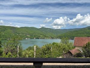 a view of a lake from a bench at Perucac Apartman in Perućac +3 photos