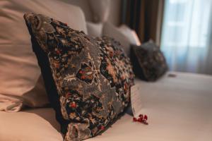 a pillow sitting on top of a bed at Boutique Hotel De Doelen in Groningen