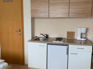 a kitchen with a sink and a counter top at Ferienwohnung "Zirbenduft" im Landhotel Seeg in Seeg