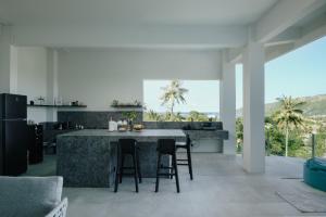 a kitchen with a large island in the middle of a room at Tris Villas ocean view in Kuta Lombok