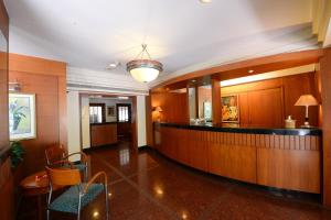 a lobby with a bar in a building at Trance Oakwood Hotel in Pune