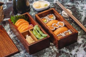 two wooden boxes filled with different types of sushi at Sina The Gray in Milan