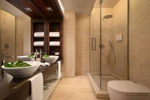 a bathroom with two sinks and a shower at Sina The Gray in Milan +18 photos