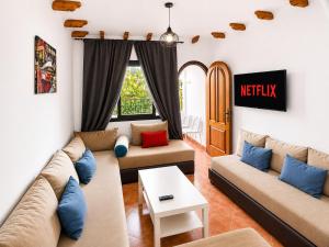 a living room with two couches and a table at Andalucia Cabo in Cabo Negro