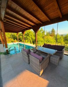 a patio with chairs and a table and a pool at Hellena 2 in Sarajevo