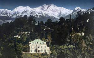 a house on a hill with snow covered mountains at Nizel Inn in Darjeeling