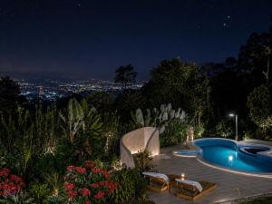 a swimming pool at night with a city at Manigelang Villa in Munduk +58 photos