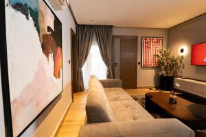 a living room with a couch and a table at Grande Candor Exclusive Hotel in Warri Airport